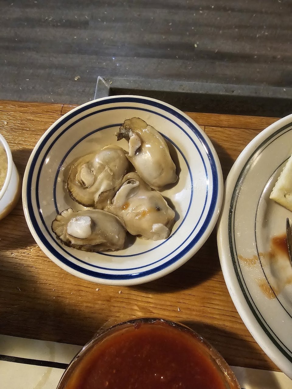 Oyster bar menu listing half-dozen and dozen portions.