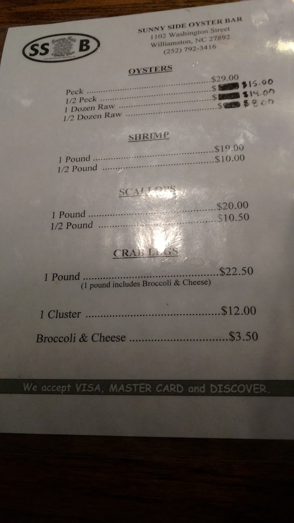Menu sections for oysters, shrimp, scallops, and drinks.